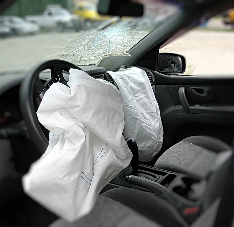 A damage vehicle with two deployed airbags and a windshield cracked.